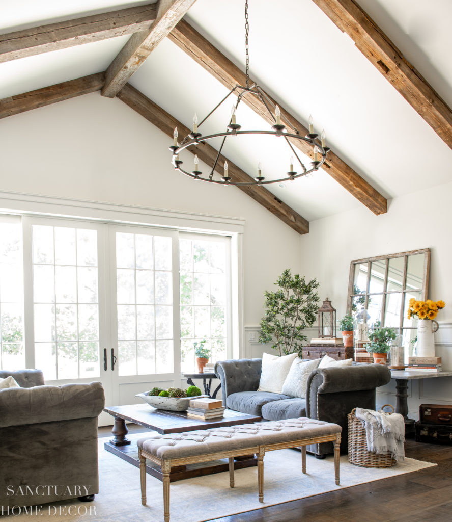 Rustic elegant living room with chesterfield couches and yellow decor accents. Faux greenery.