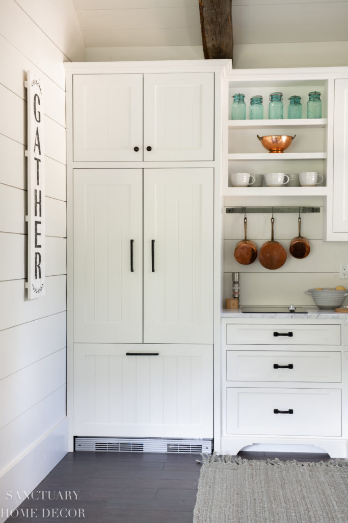 Small kitchen with paneled refrigerator