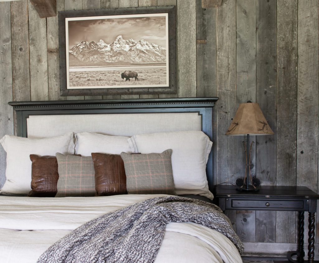 reclaimed barn wood wall with linen bed.