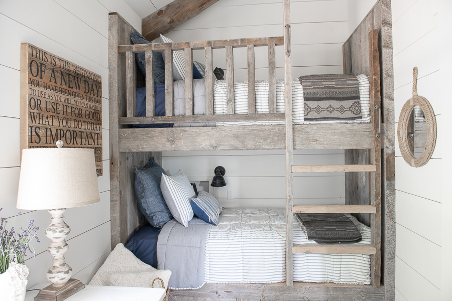 Reclaimed barn wood bunk beds in kid's bunk room. Shiplap walls.