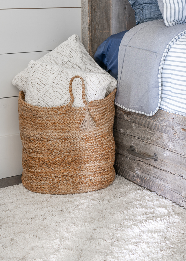 Jute basket in bunk room with knit pillows