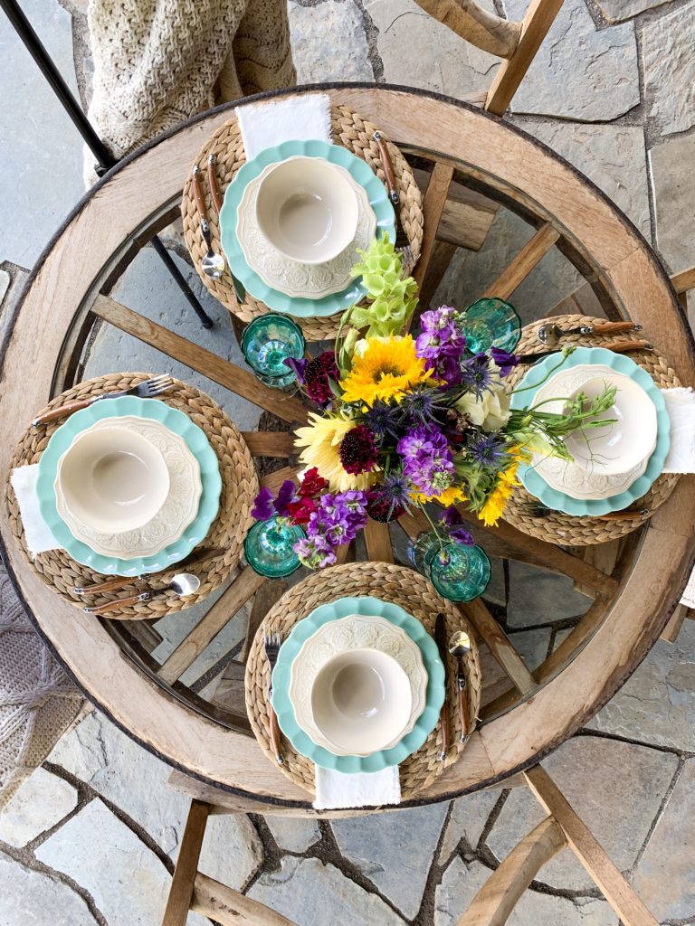 Colorful vintage chic table setting with turquoise and white plates