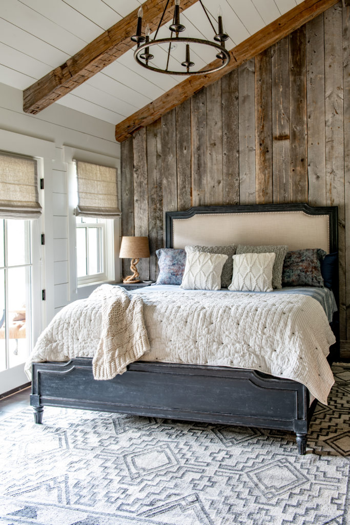 Bedroom with reclaimed wood accent wall.