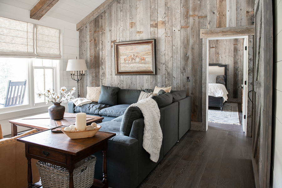 Small living room with shiplap, barn wood accent wall and fabric shades