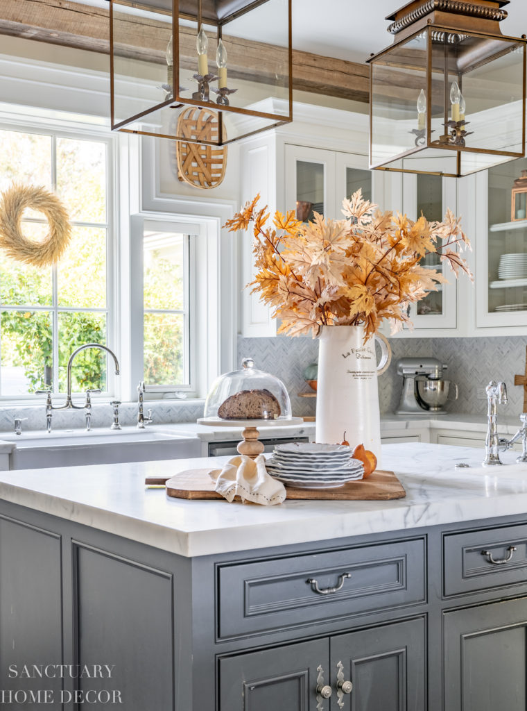 Farmhouse kitchen with fall decorating. Faux fall maple branches. Farmhouse sink.