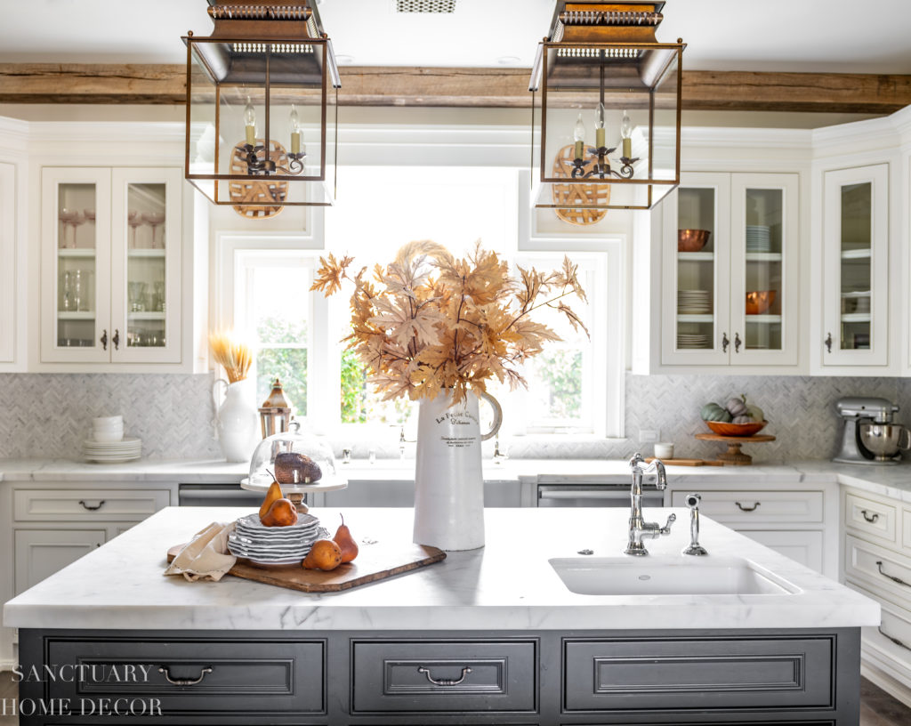 Farmhouse kitchen with fall decorating. Faux fall maple branches. Farmhouse sink.