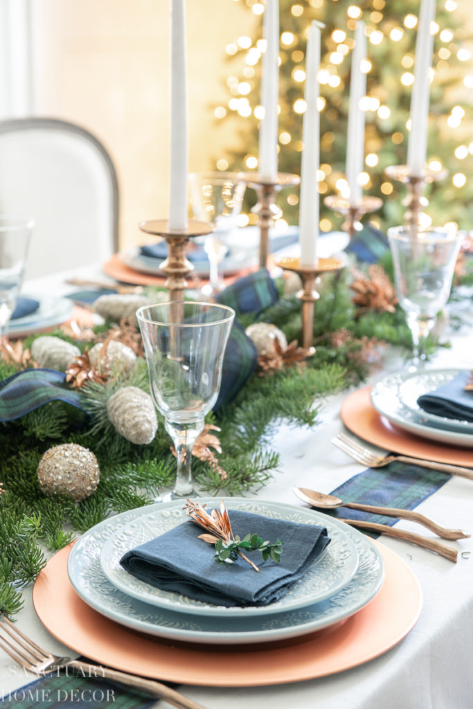 Christmas dinner table decorations in blues and gold following a