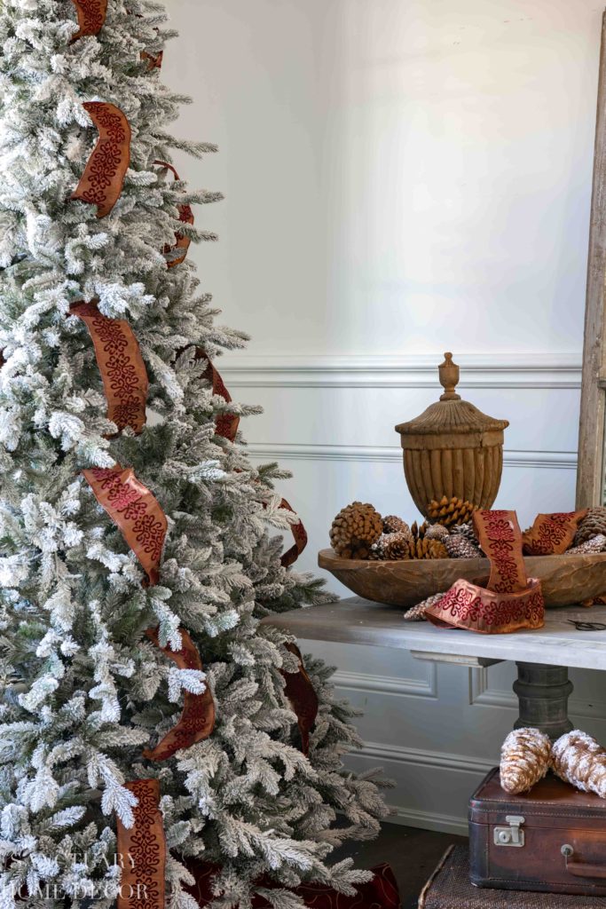 putting ribbon on small christmas tree