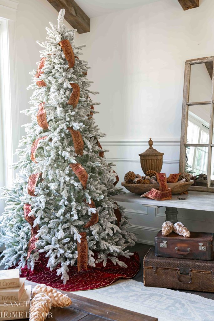 putting ribbon on small christmas tree