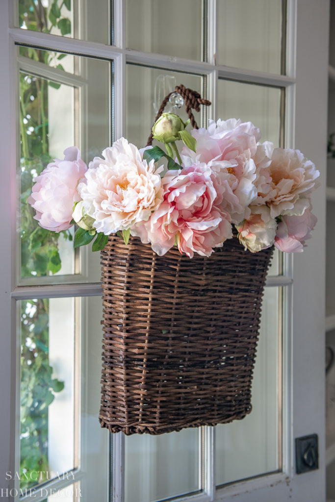 realistic faux peony arrangement in hanging basket