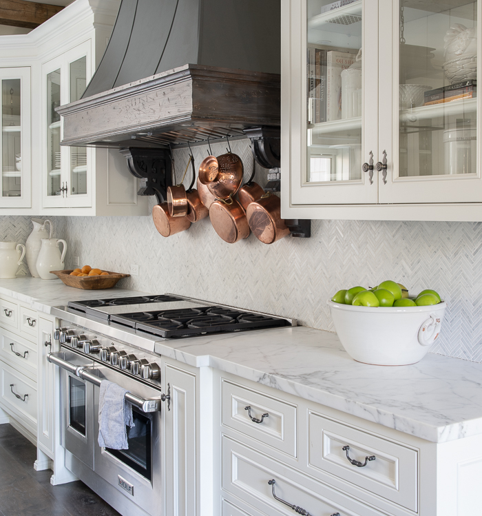 White marble kitchen counter top with a stove in a modern home